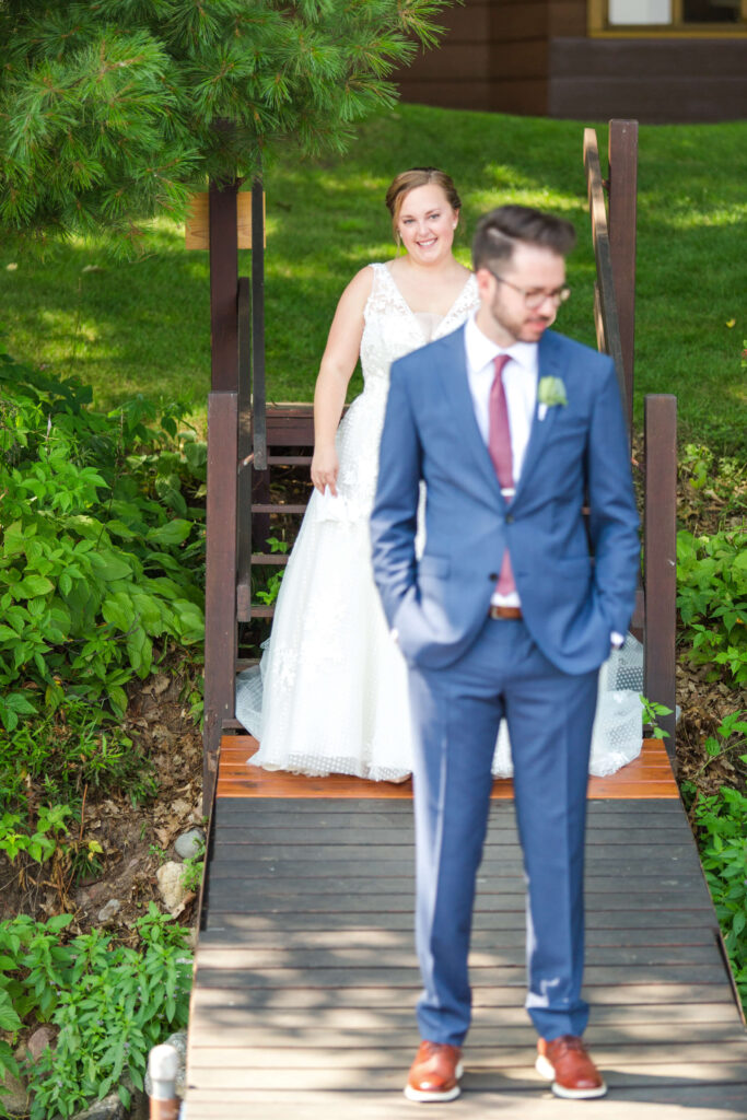 Bride & groom share a first look on dock at elegant wedding at Red Crown Lodge