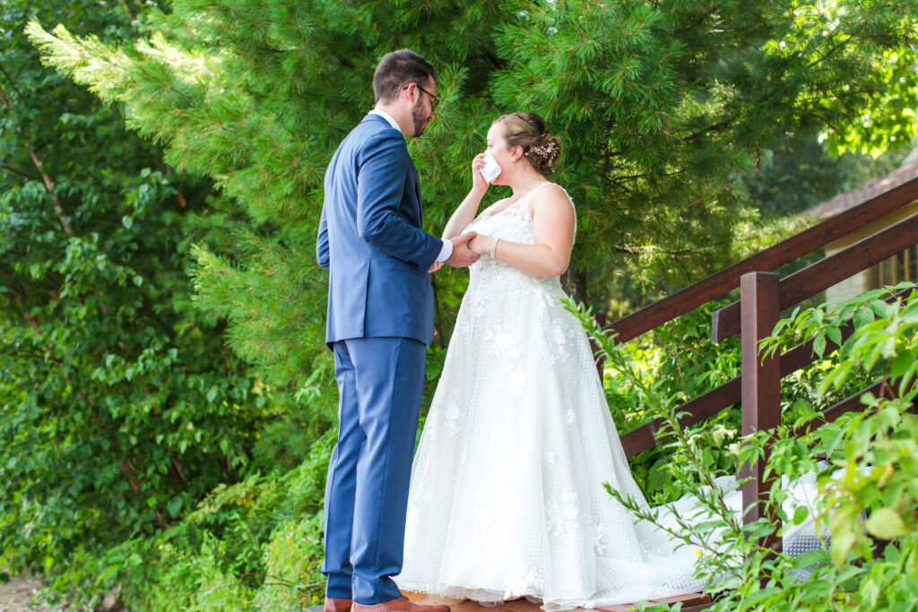 bride sheds tears at first look at elegant wedding at Red Crown Lodge