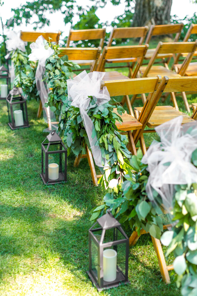 ceremony site with greens and lanterns at elegant wedding at red crown lodge
