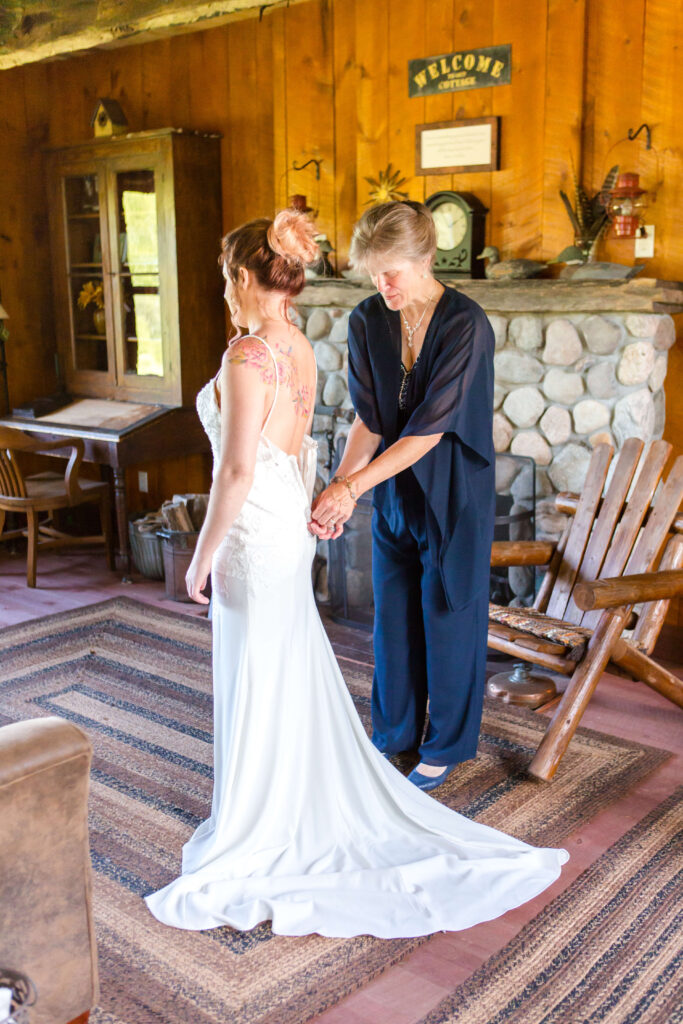 Mom helping bride at her Eagle River Cabin Wedding