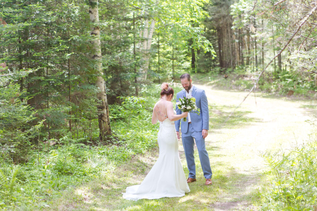 bride & groom first look at their Eagle River Cabin Wedding