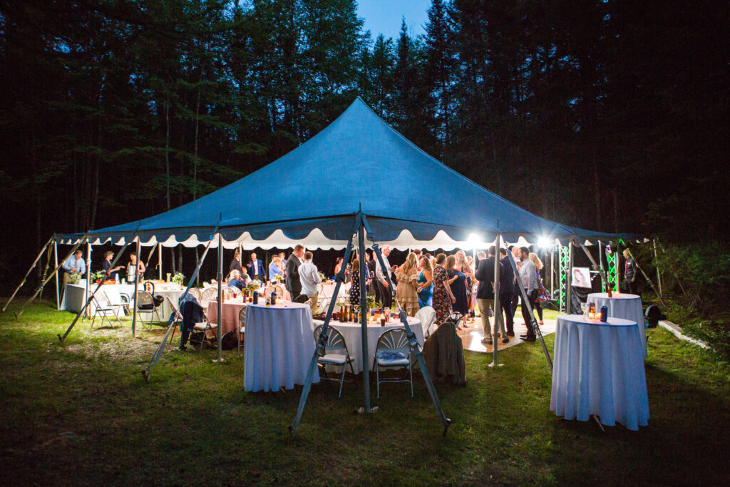 White reception tent lit up at night Eagle River Cabin Wedding