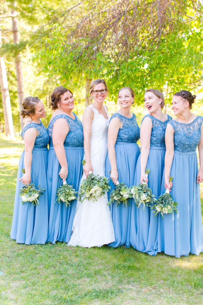 Bride and Bridesmaids in blue dresses with lace detailing at Eagle Waters resort