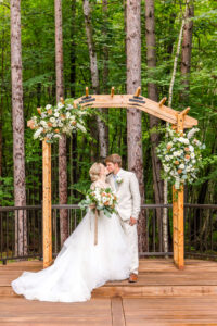 bride & groom pose for photos at their Pines Event Center Wedding