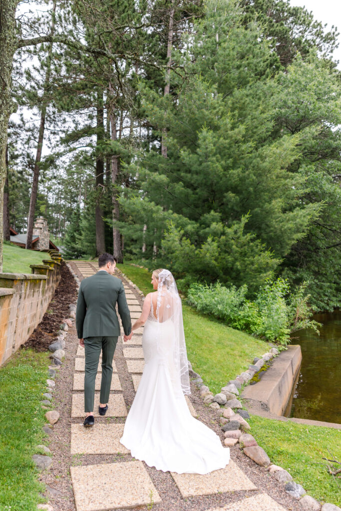 Bride & Groom walking up the path at Chippewa Retreat