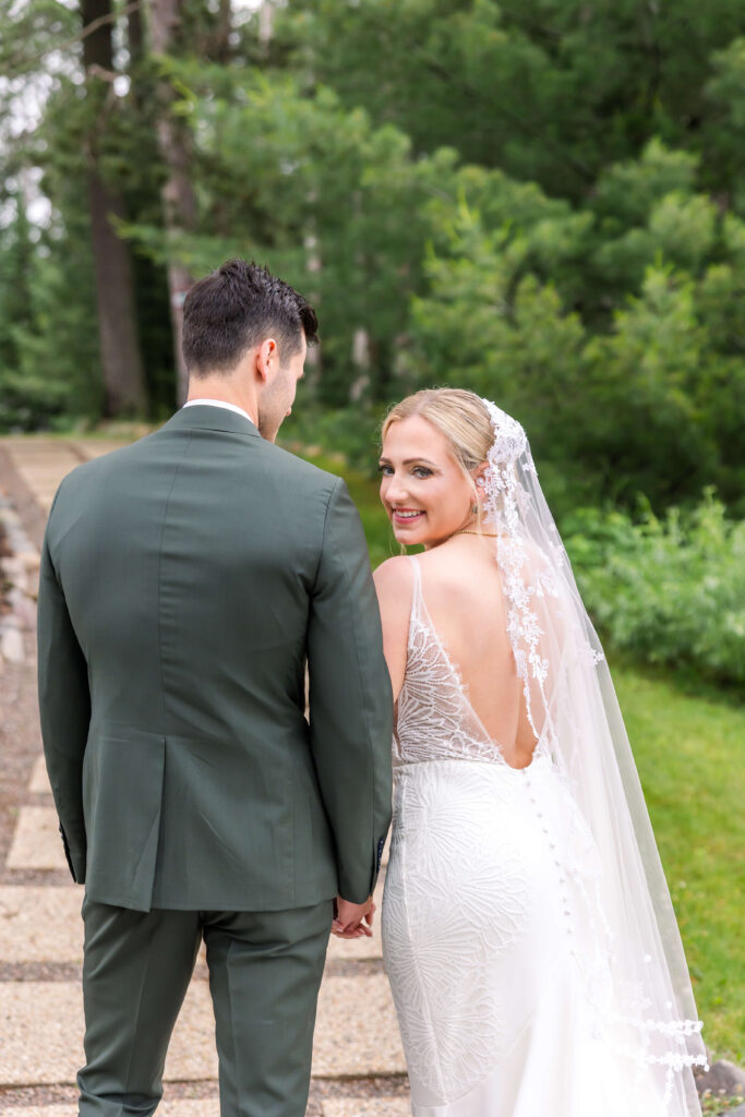 Bride & Groom walking up the path at Chippewa Retreat